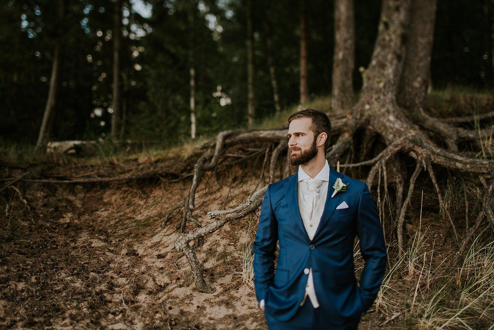 groom portrait session in forest