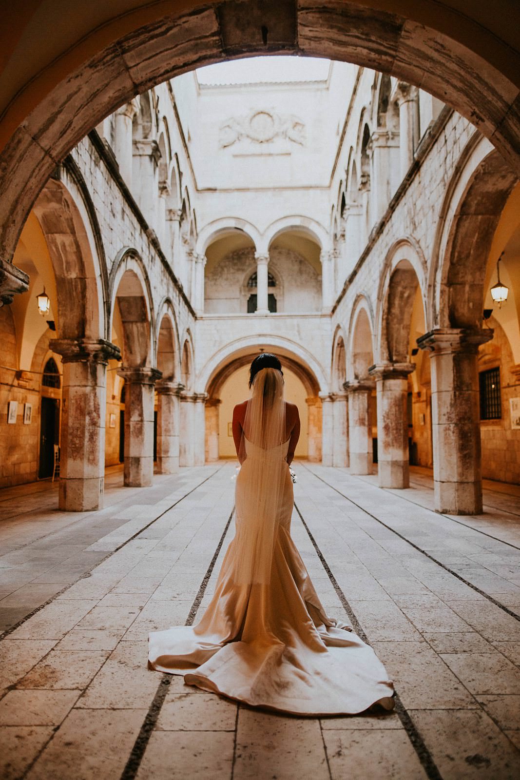 bride walking down the isle in Sponza Palace Dubrovnik