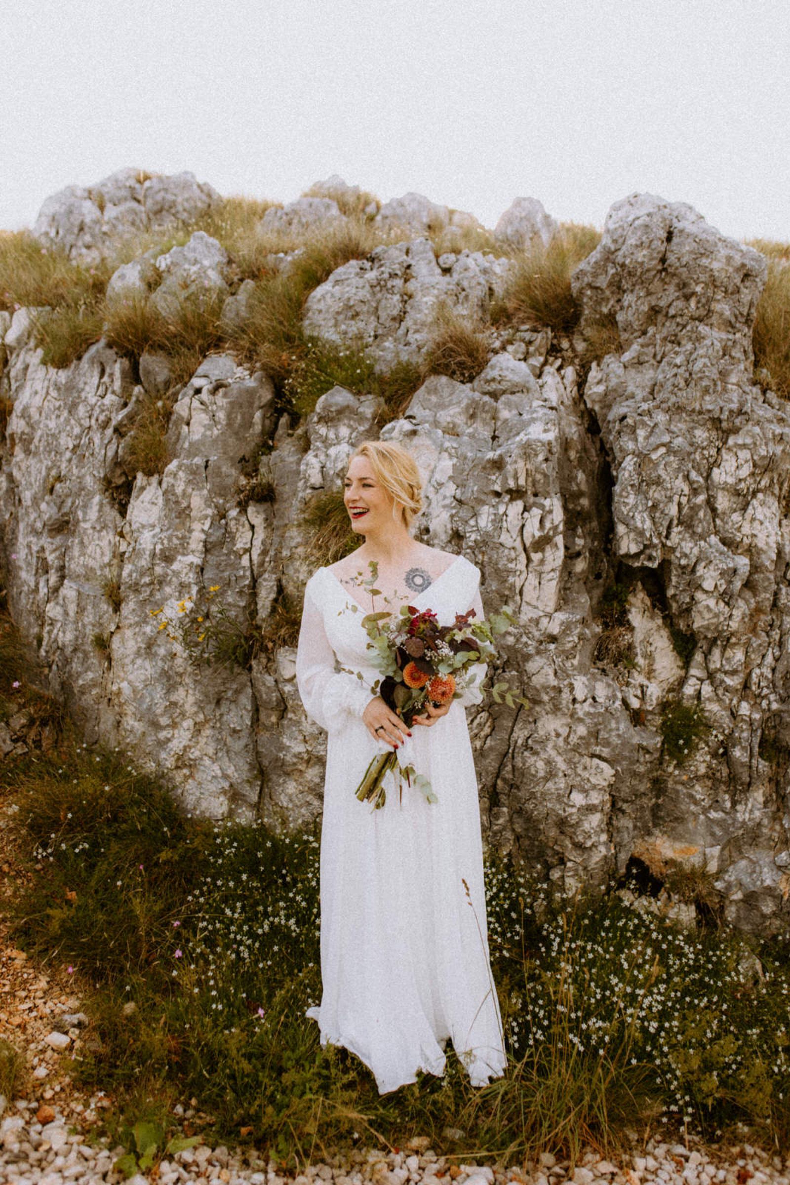 a portrait of a bride holding a flower bouquette