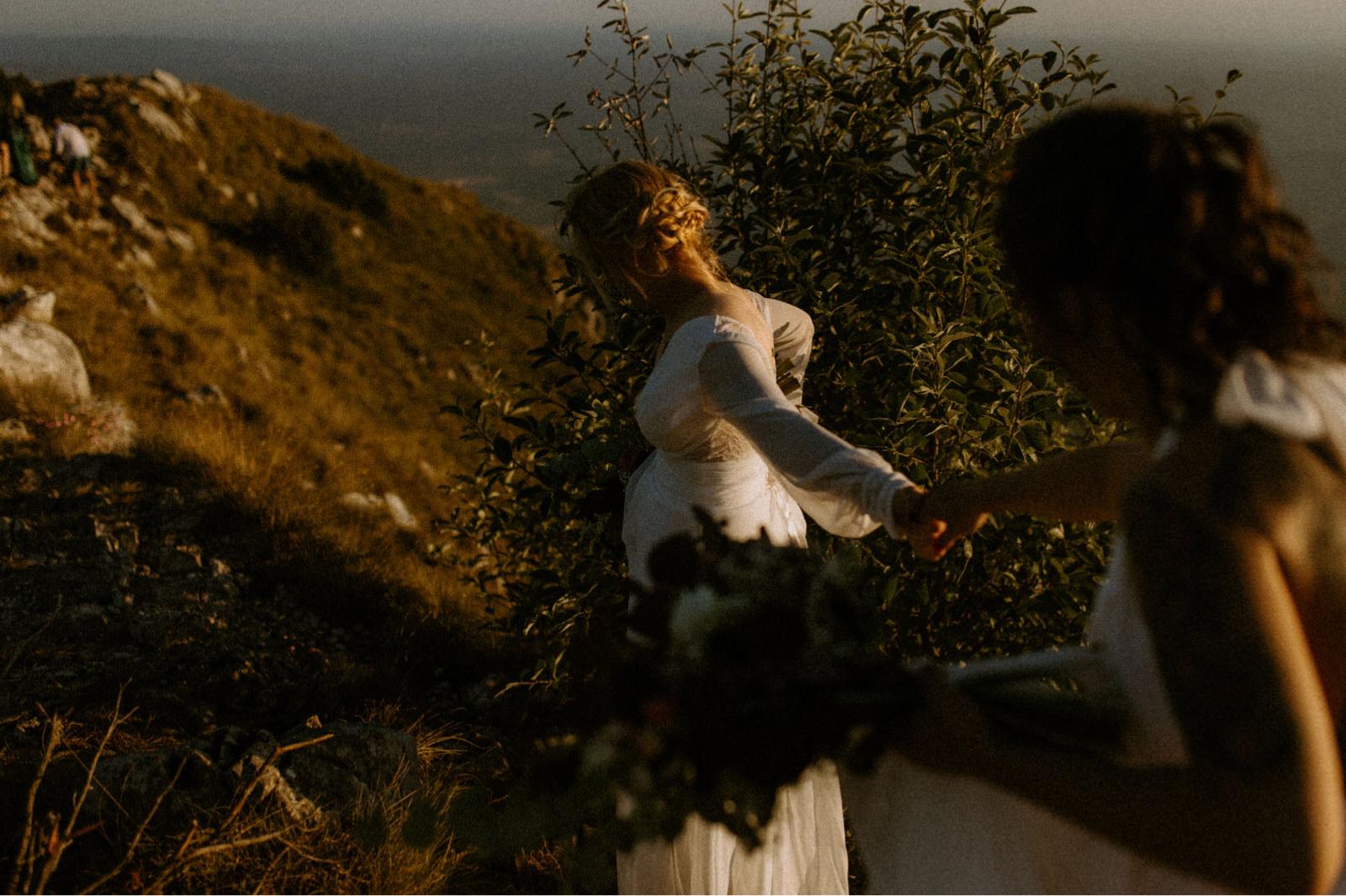 brides holding hands on top of mountain Ucka in Croatia
