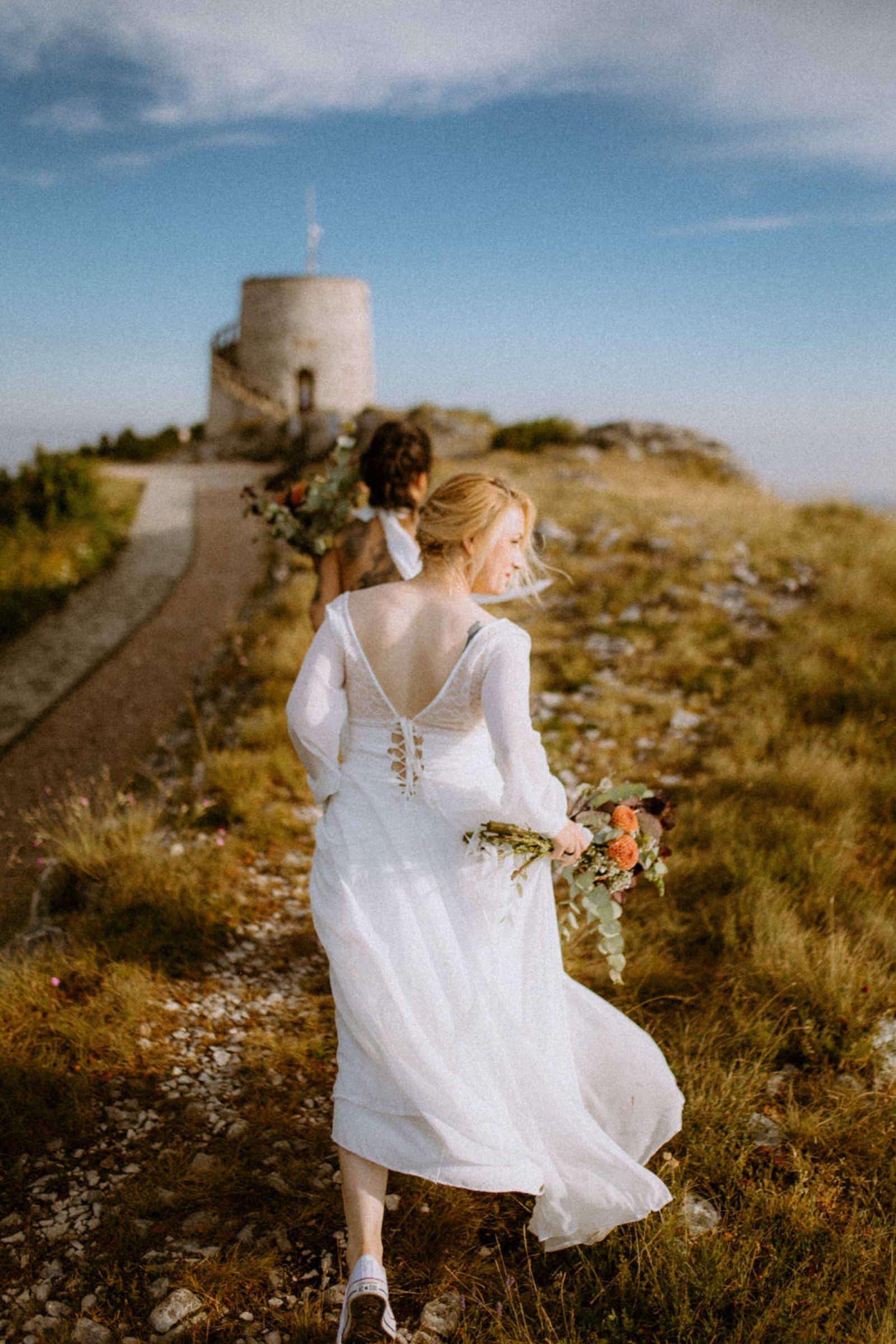two brides walking to the spot where they will exchange their vows on mountain Ucka in Croatia