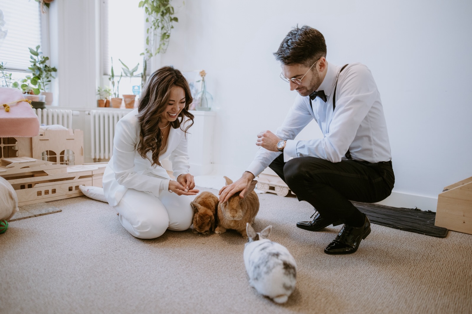 bride and groom with their bunnies in their apartment before they leave to get married in the city hall