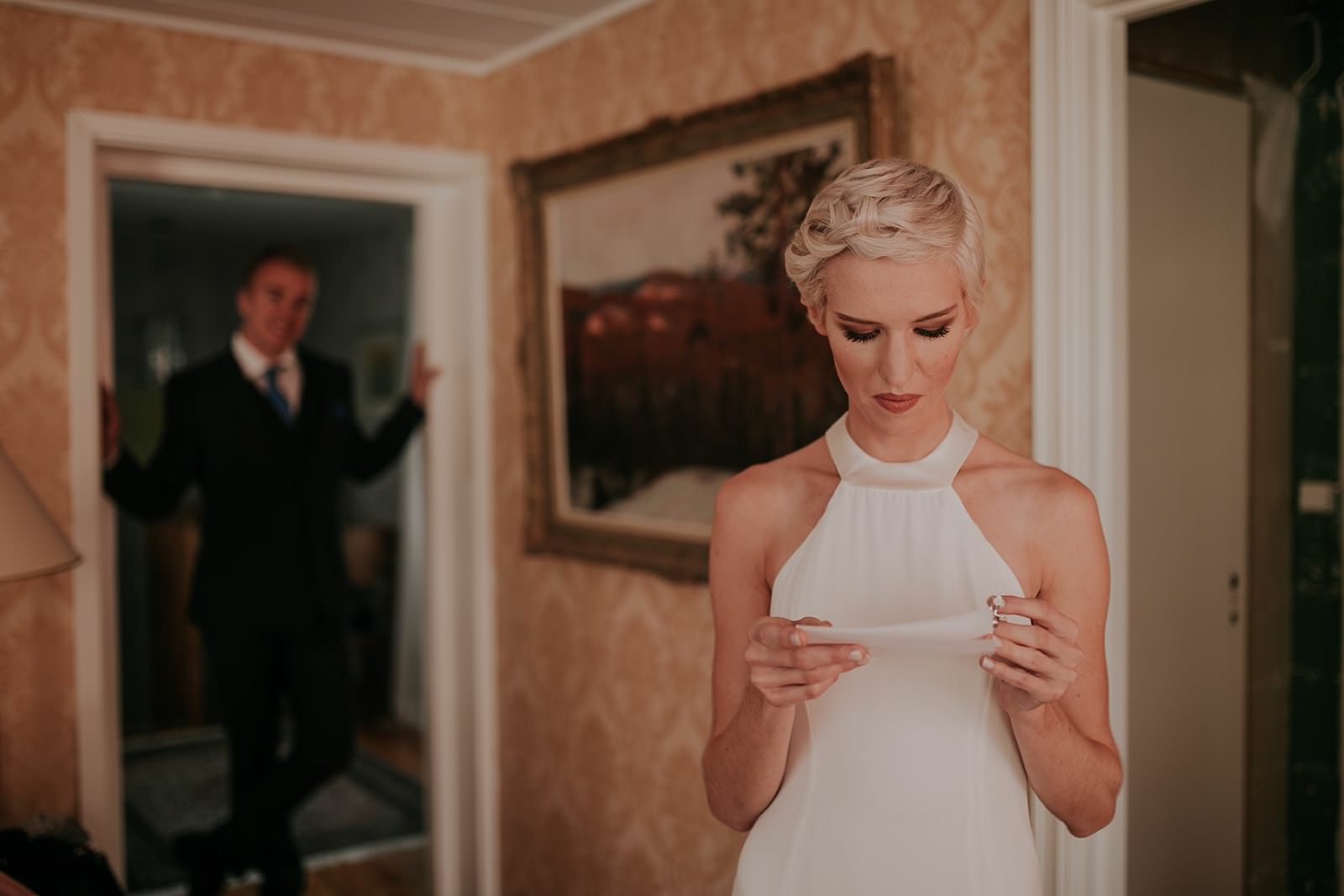 bride reading a love note from groom on her weddingday