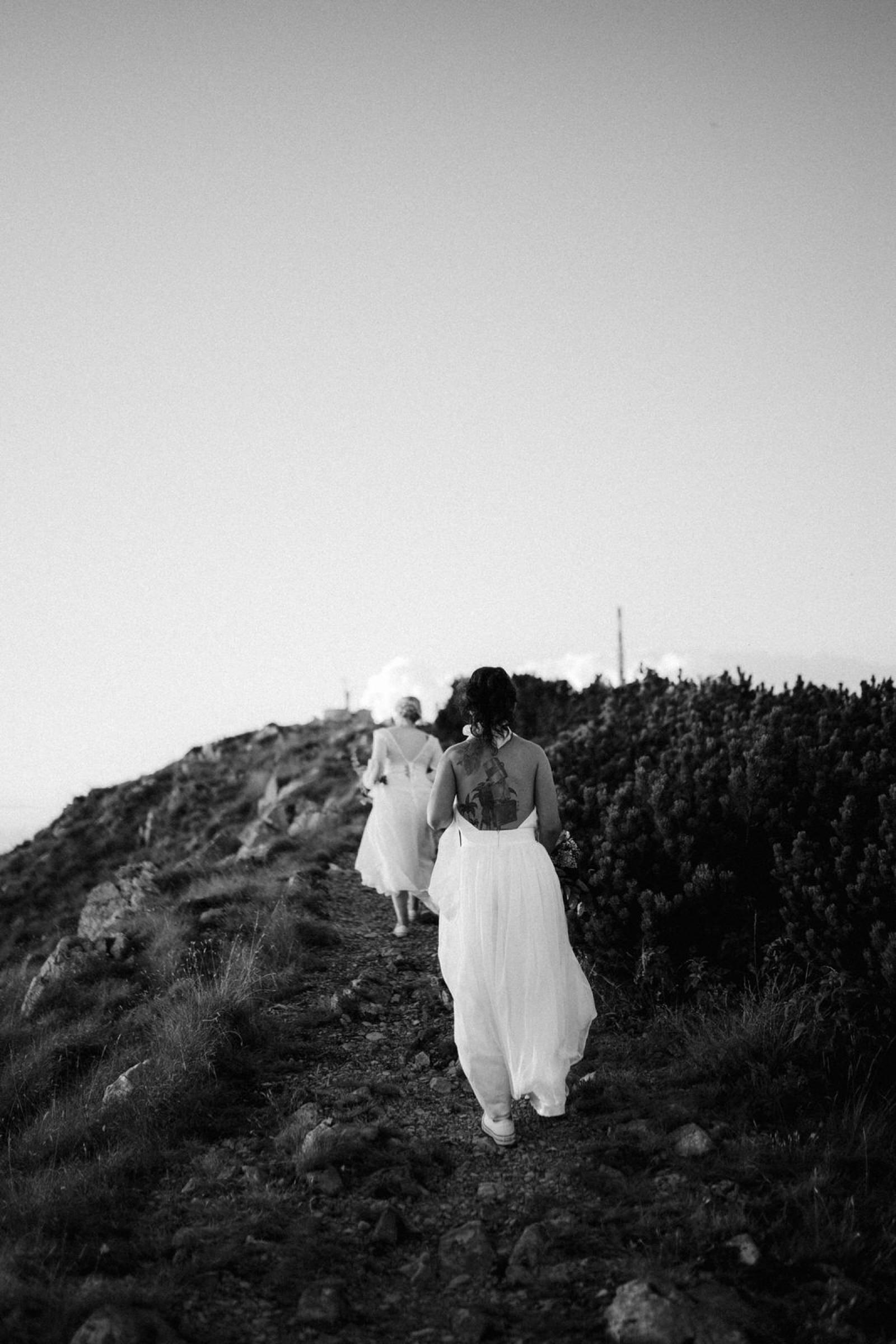 two brides walking on the top of the mountain