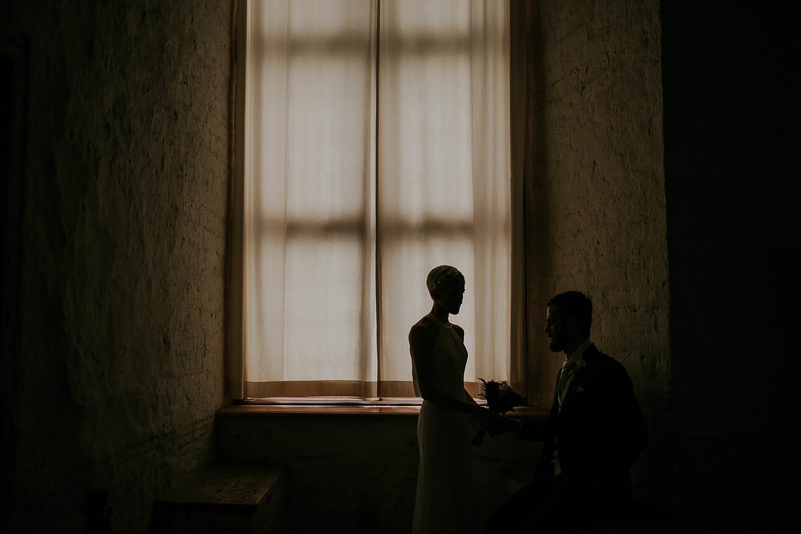 bride and groom in Vadstena castle before their ceremony