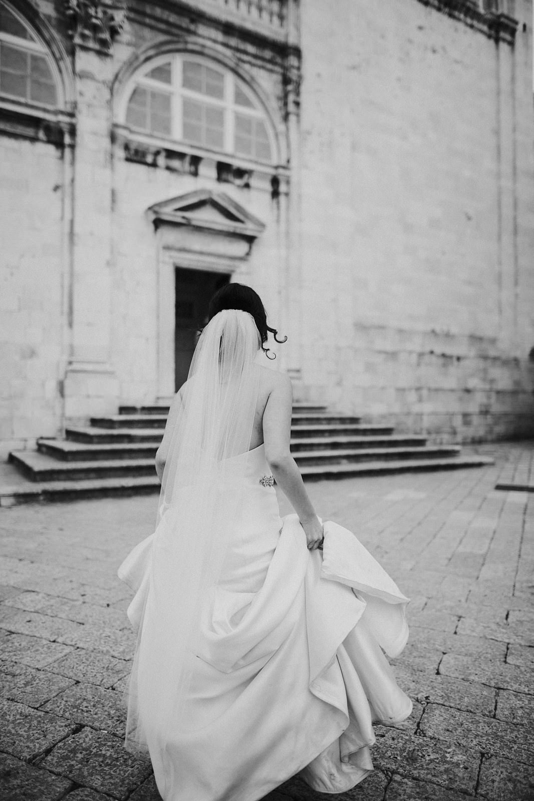 bride on her wedding day running the streets of Dubrovnik
