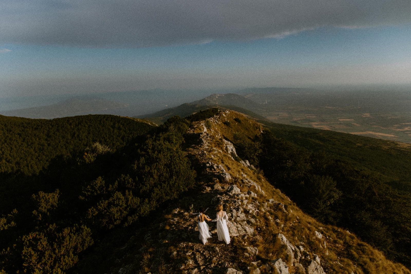 brides holding hands on top of mountain Ucka in Croatia