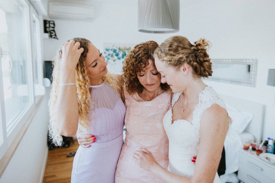 bride with her mother and sister getting ready