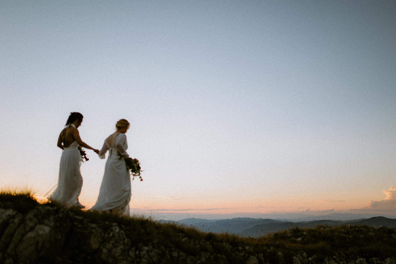two brides walking into sunset in Croatia