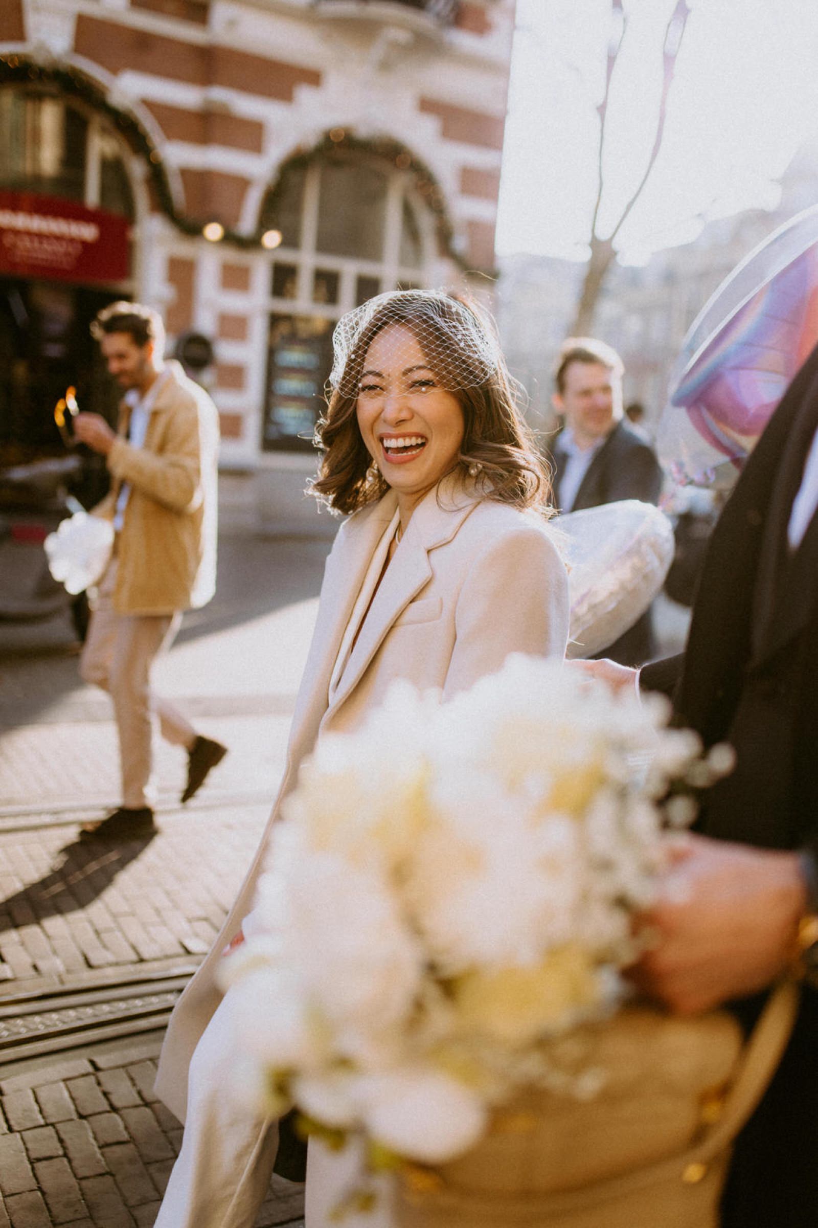 bride walking down the street and laughing